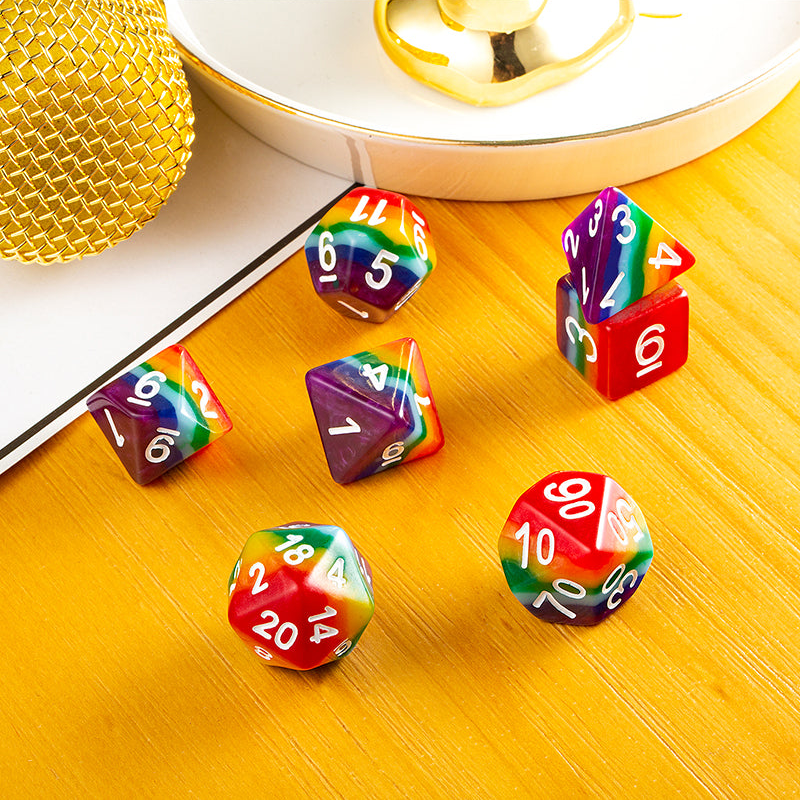 Set of colorful dice with numbers on a wooden surface.