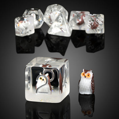 Transparent dice with embedded animal figures on a dark background